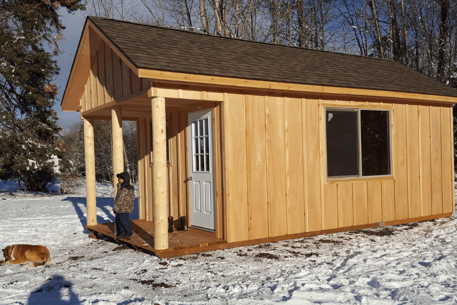 Cabin in snow Timber Beams on porch A frame roof