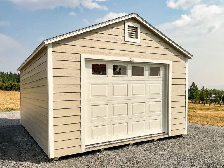 A beige garage with decorative white trim and a double door with windows.