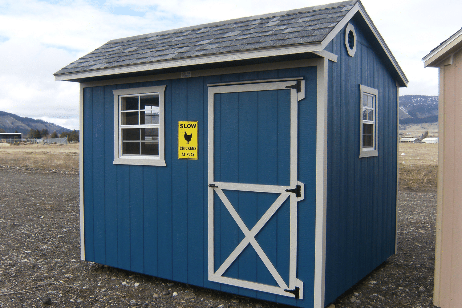 blue chicken coop with white trim and windows in elgin oregon