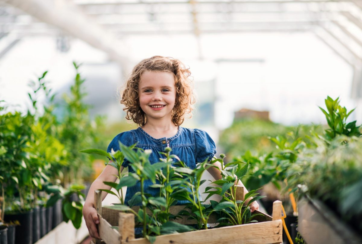 girl in small greenhouse