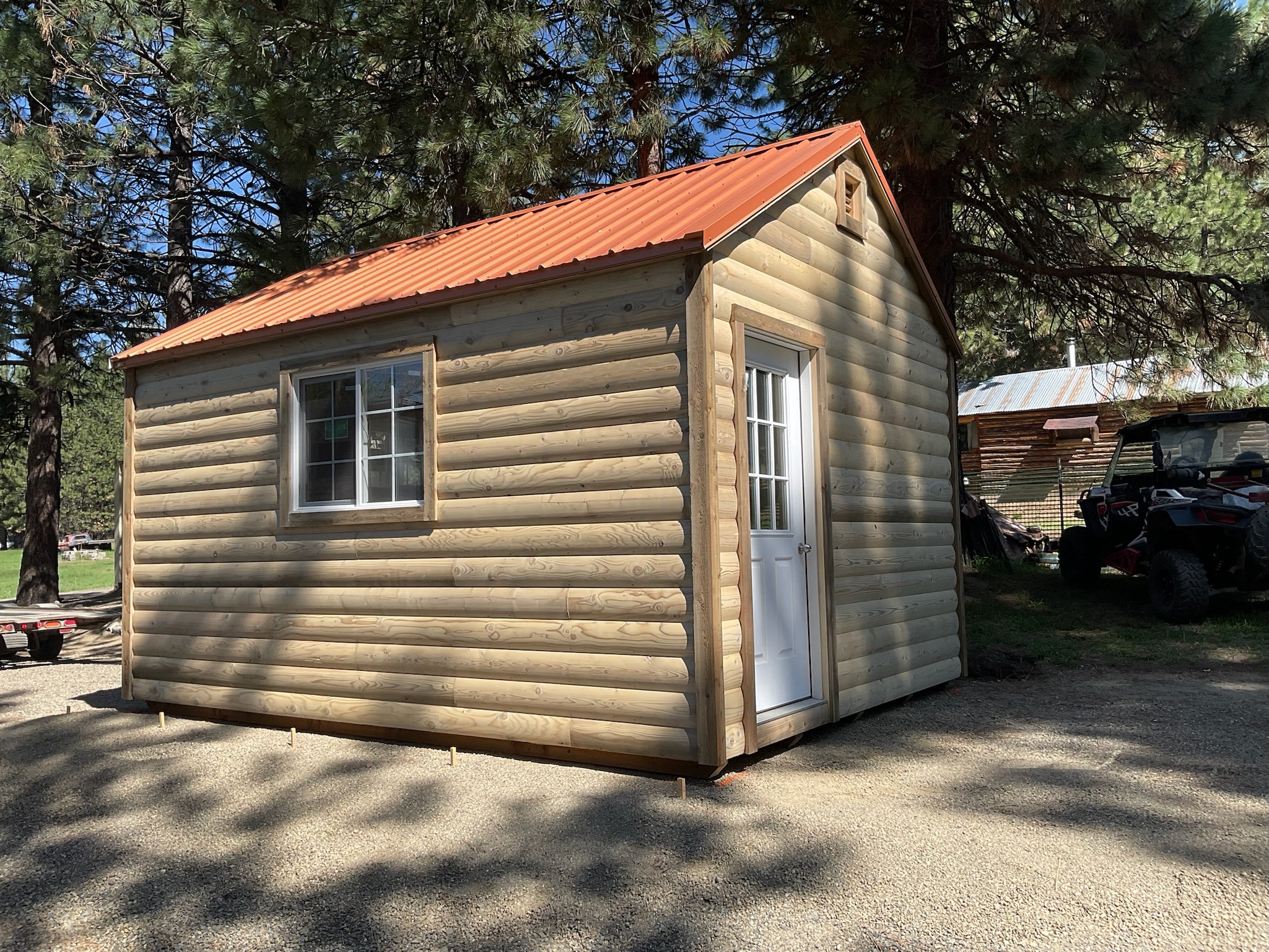 A rustic wooden cabin featuring a durable metal roof